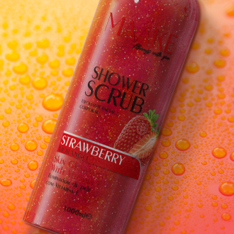 Close-up of Strawberry Glowing Shower Gel Scrub in hand, showing rich lather and exfoliating particles